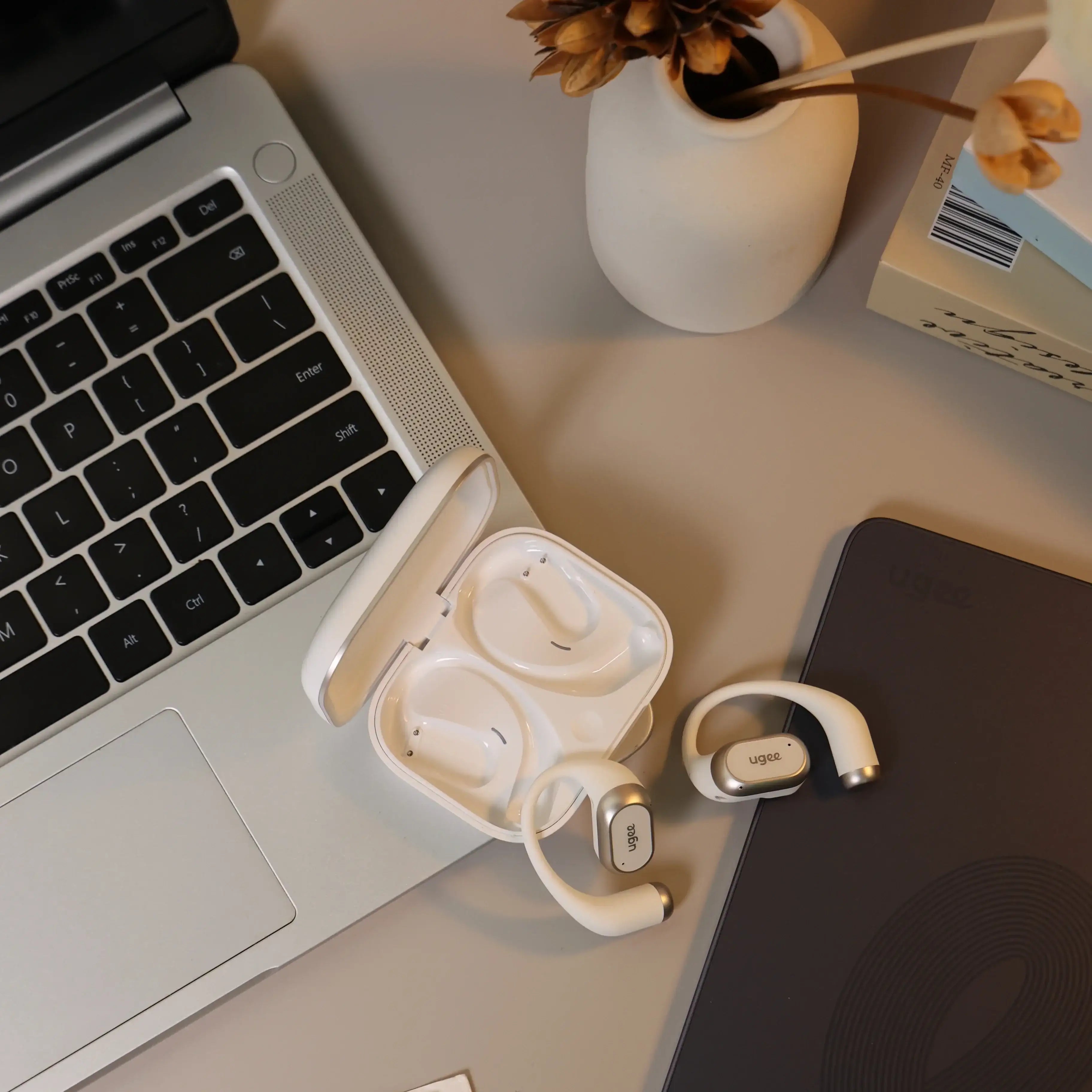 Fresound Inspiration open earbuds with charging case on modern desk workspace, ideal for office or home use